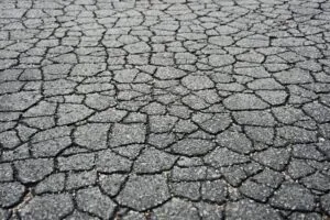 cracked asphalt road in need of asphalt crack filling