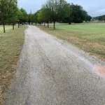 cracked asphalt driveway surface showing long-term wear