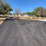 wide newly paved asphalt driveway with clean surface finish