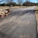 newly installed asphalt driveway with curved layout and clean edges