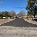 newly paved asphalt driveway entrance with smooth finish