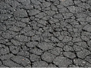 Severe alligator cracking on deteriorating asphalt pavement