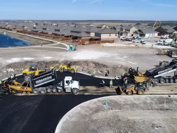 Alpha paving truck in the middle of a dirt lot