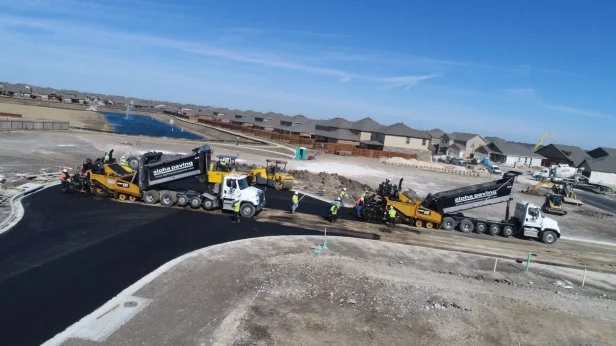large trucks laying concrete pavement
