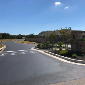 Entrance of Texas HOA Street After Asphalt Paving and Sealcoating Services By Alpha Paving