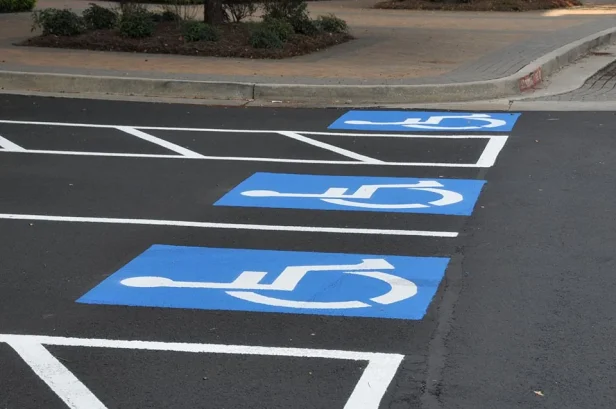 Close up of ADA Compliance parking lot striping in Austin, Texas with 3 handicap parking spaces.