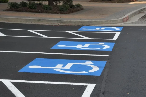 Close up of ADA Compliance parking lot striping in Austin, Texas with 3 handicap parking spaces.