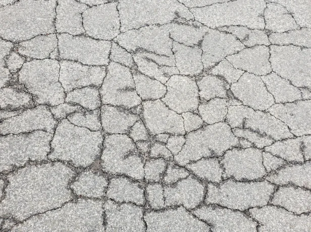 Cracks forming in asphalt pavement